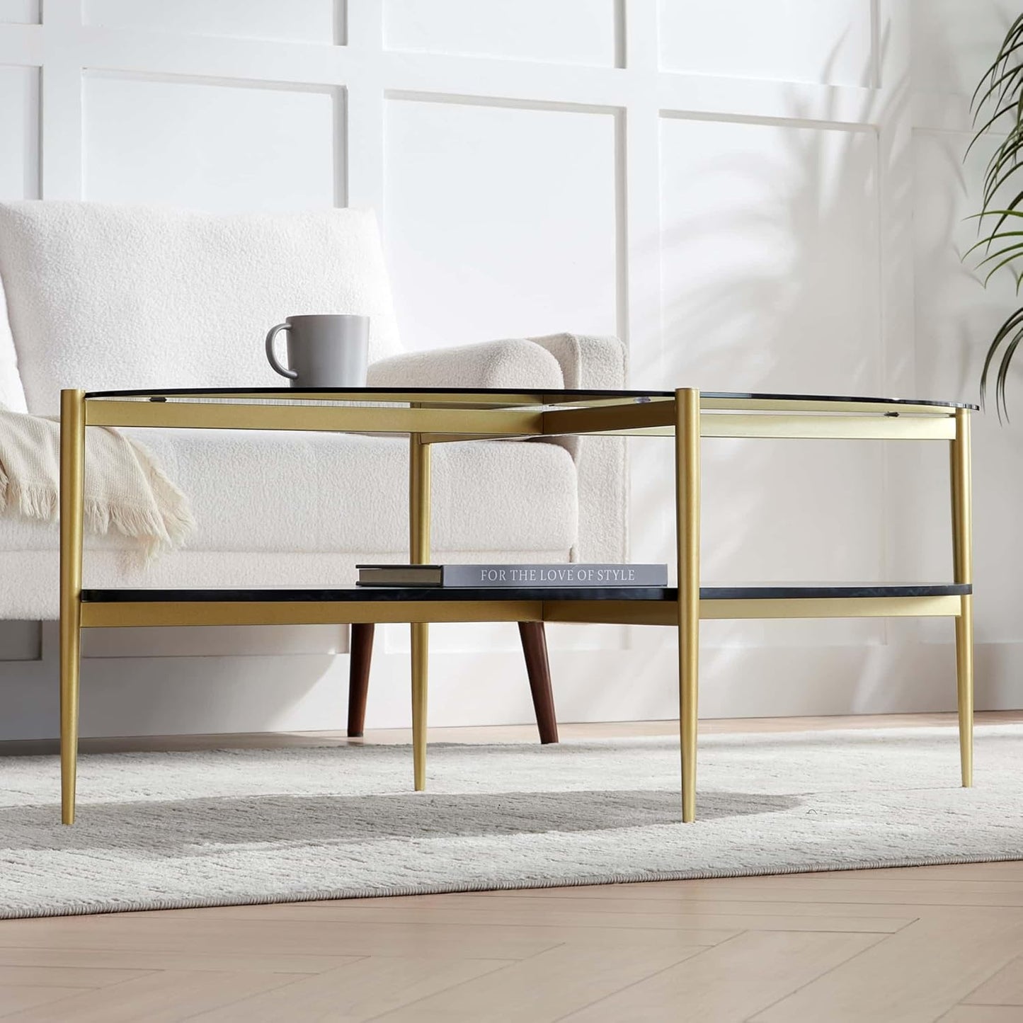 Oval Glass Coffee Table, Mid-Century Modern Design, L43 x W22 x H17 inch, Surfboard Shaped Grey Glass Top and Black Marble Finish Wood Shelf, Tapered Legs with Gold Finish Frame